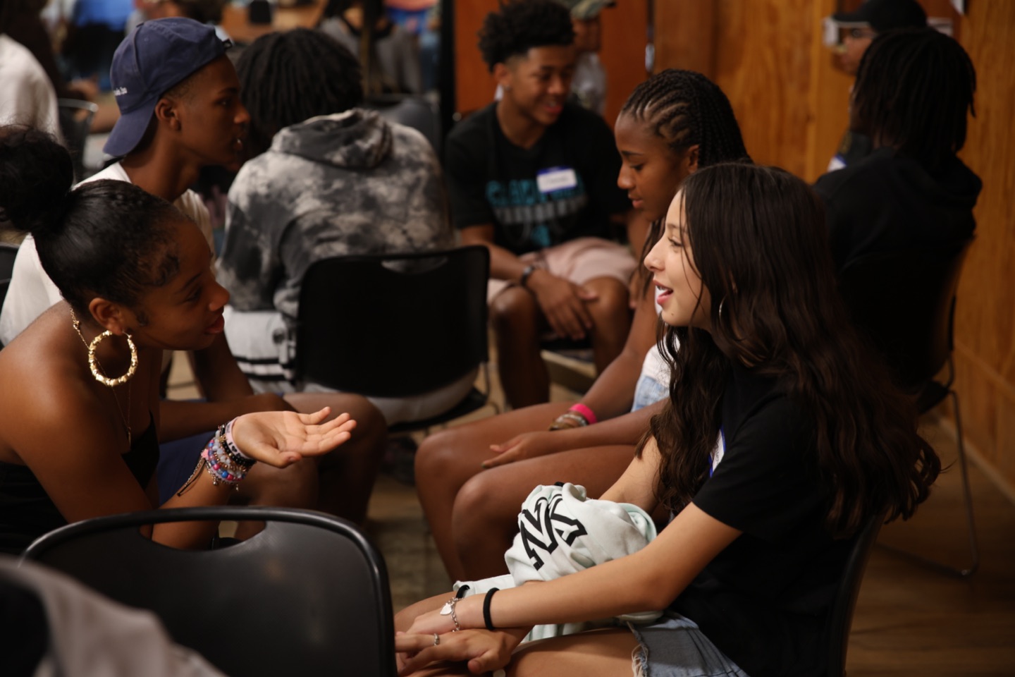 Two teens in deep conversation at an MTS program session